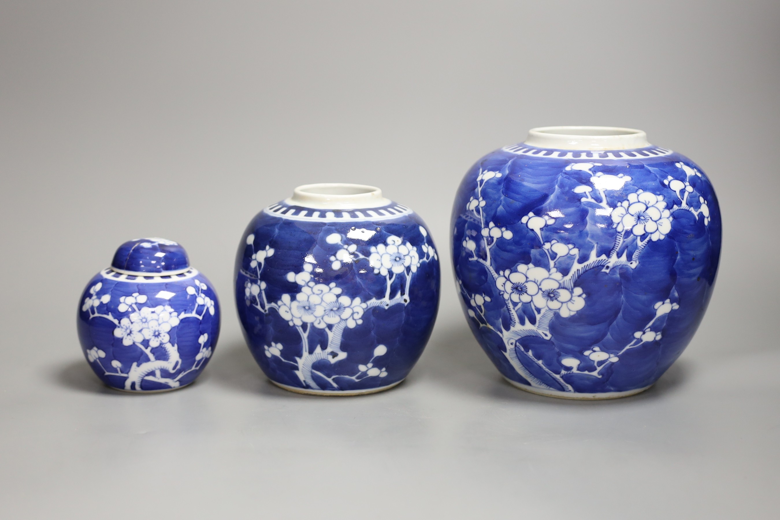 Three Chinese blue and white prunus blossom jars, tallest 17cm
